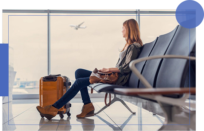 A woman sitting on the bench at an airport